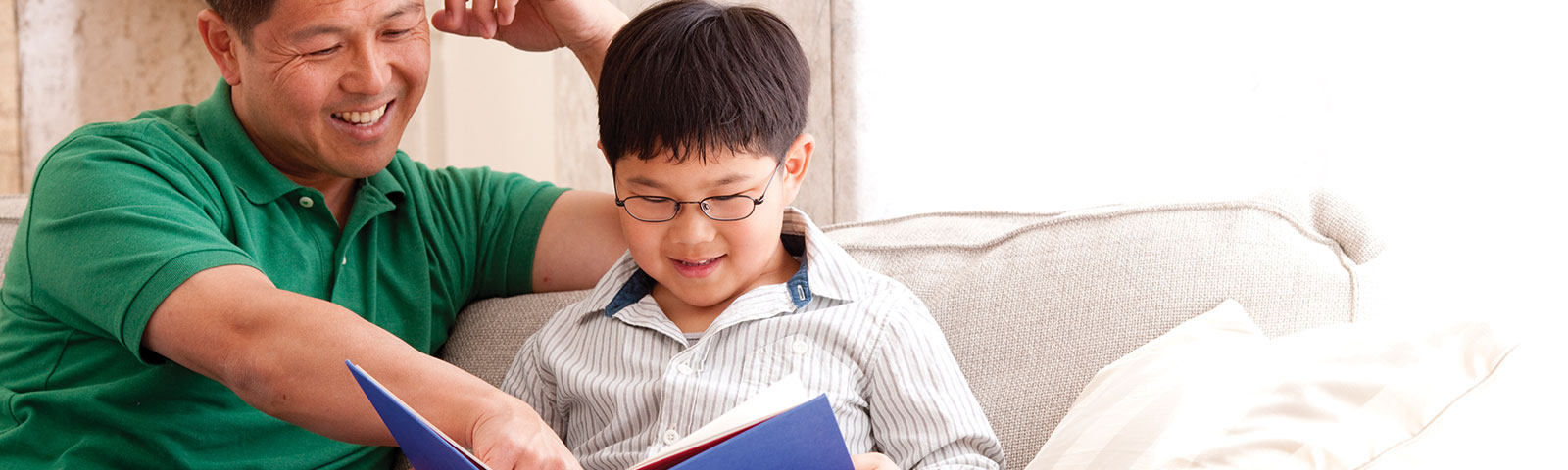 Man and child reading a book